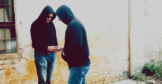 two men taking part in a drug deal